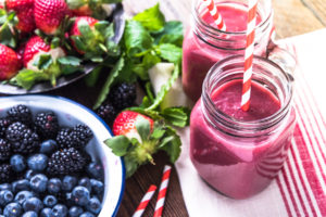 Well being and weight loss concept berry smoothie.On wooden table with ingredients from above. ** Note: Shallow depth of field